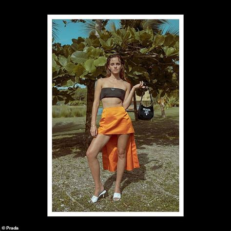 Emma Watson stuns in a revealing black bandeau top and bold orange ...