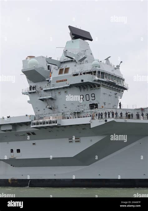 Crew line the decks as the Royal Navy aircraft carrier HMS PRINCE OF WALES returns home from ...