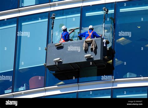 Window cleaners suspended in a cradle washing glass curtain walls of Stock Photo, Royalty Free ...