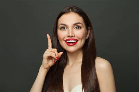 Premium Photo | Happy woman pointing up on black banner background