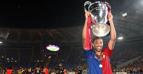 Thierry Henry of Barcelona lifts the Champions League trophy after the ...