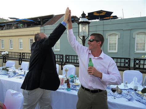 High fiving one of the Groomsmen! That's the Rooftop Bar of the Vendue Inn in the background ...