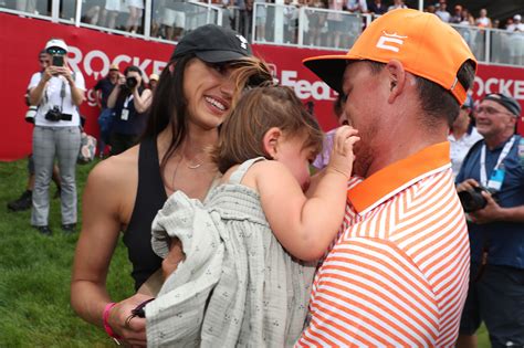 Rickie Fowler embraces wife Allison Stokke after Rocket Mortgage Classic