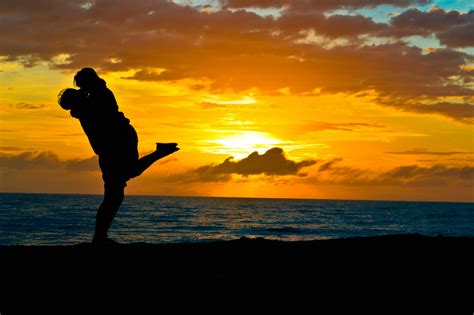 Silhouette of Two Couple Standing on Seashore · Free Stock Photo