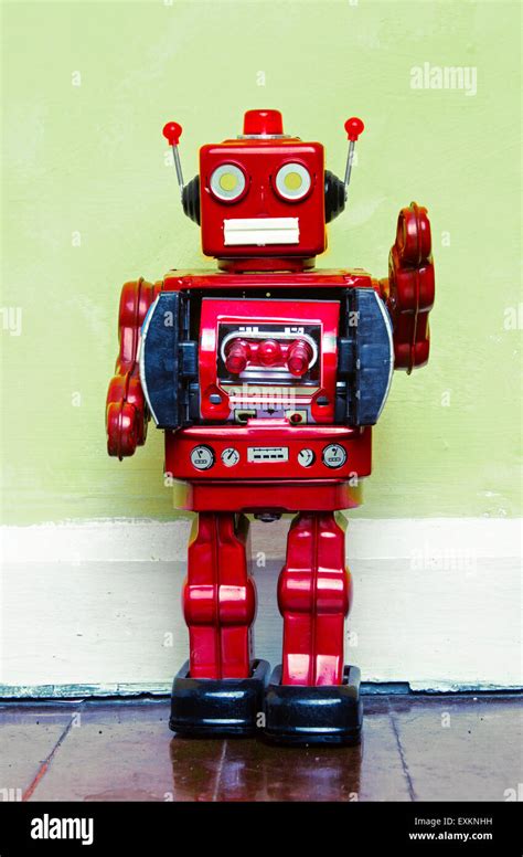 retro red robot toy on a wooden floor Stock Photo - Alamy