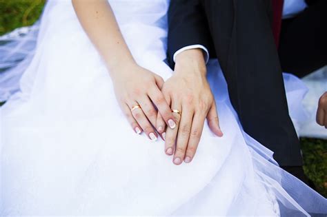 Premium Photo | Closeup of two hands of young adults with wedding rings