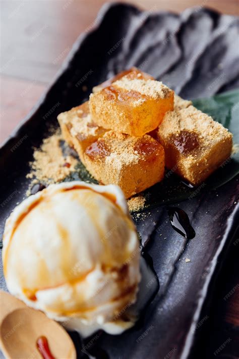 Premium Photo | Warabi Mochi served with a scoop of vanilla ice cream that topping with caramel.