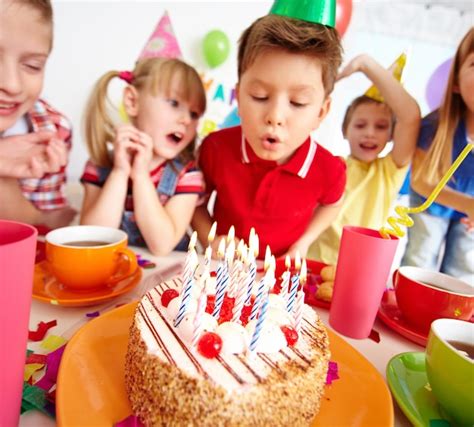 Kids blowing candles on birthday party Photo | Free Download