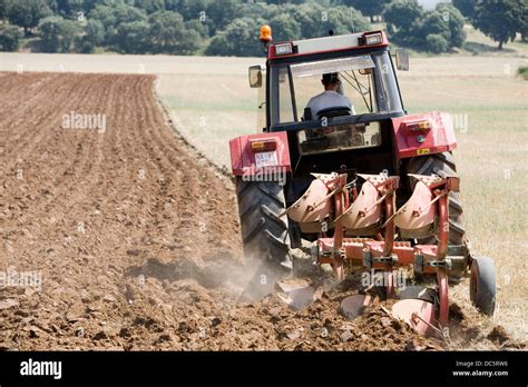 Agricultural machinery. Tractor ploughing the land. Mouldboard Stock ...