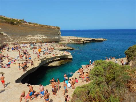 many people are on the beach and in the water at this point, there is ...