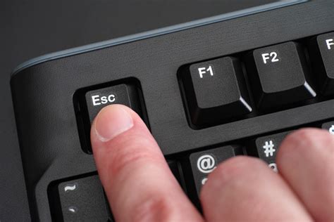 Finger Pushing Esc Key On Black Keyboard Stock Photo - Download Image ...