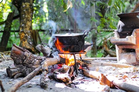 Burning Firewood in the Fireplace with Old Black Cooking Pot Stock Photo - Image of steam, camp ...