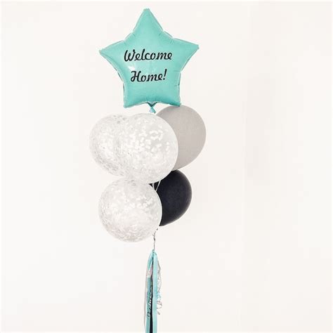 Premium Photo | A bunch of balloons with a welcome home title on a white surface