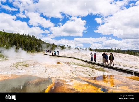 Tourists on the trail at Geyser Hill, Upper Geyser Basin, Yellowstone National Park, Wyoming ...