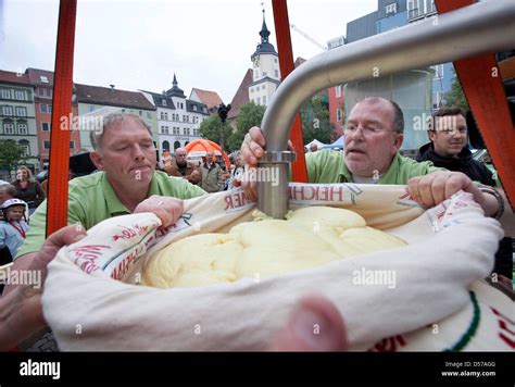 Helpers load the world's largest potato dumpling into a bag on the market square in Jena ...