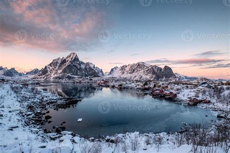 Viewpoint of snow mountain reflection on seashore in reine village ...