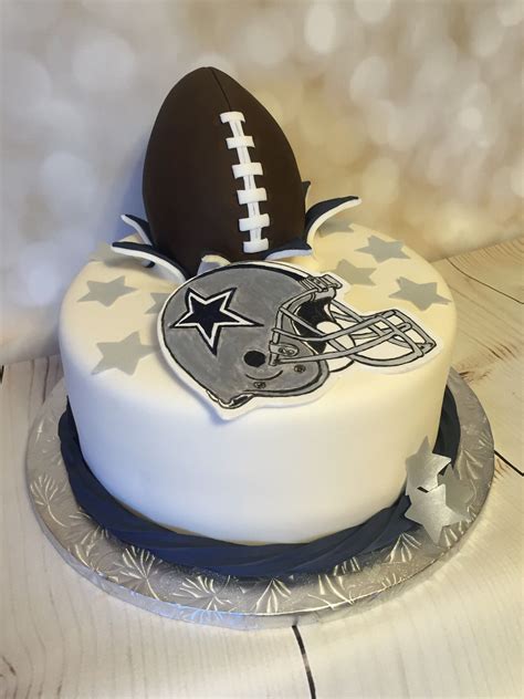 a cake with a football on top and stars around the edges is sitting on ...