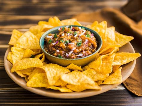 Plate of nacho chips with homemade salsa | Free Photo