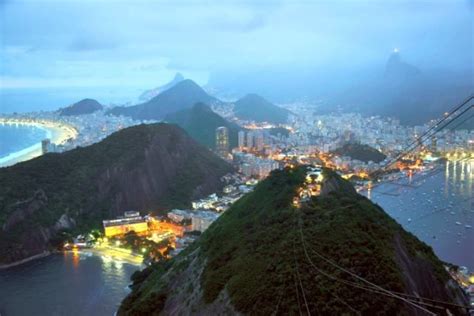 an aerial view of the city lights and mountains at night from a high ...