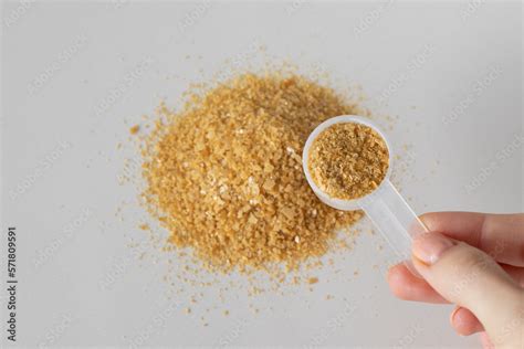 Bone broth powder with natural collagen in measuring spoon on a beige background. Stock Photo ...