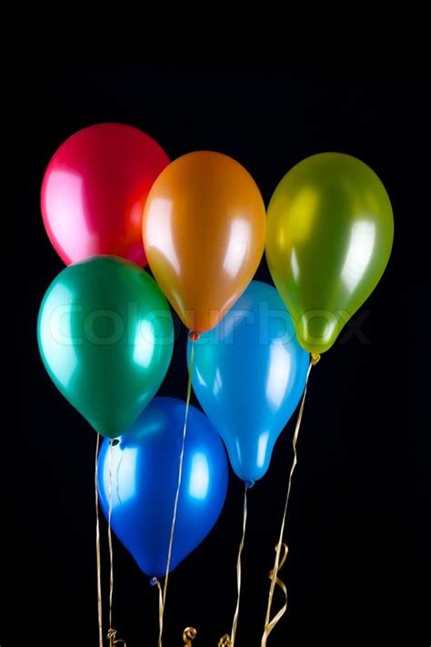 Six balloons on black background | Stock Photo | Colourbox