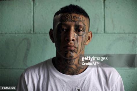 A member of the 18th street gang poses for a picture in the... News ...