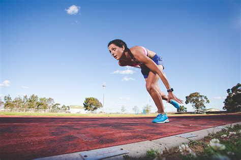 Female Fitness Model And Track Athlete Sprinting On An Athletics Track Made From Tartan Stock ...