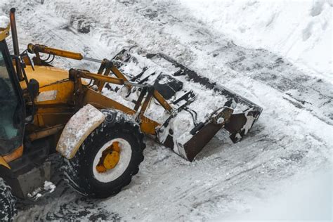 Tractor shoveling snow stock image. Image of equipment - 264170091