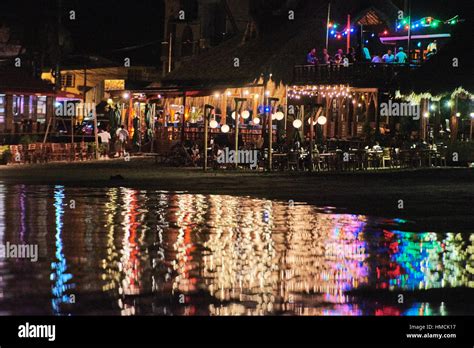 bar on beach with lights at night Stock Photo - Alamy