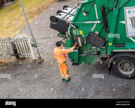 garbage truck driver empty trash in malmkoping sweden Stock Photo - Alamy