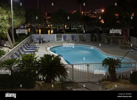 Motel swimming pool at night with no people around only the palm tree setting Stock Photo - Alamy