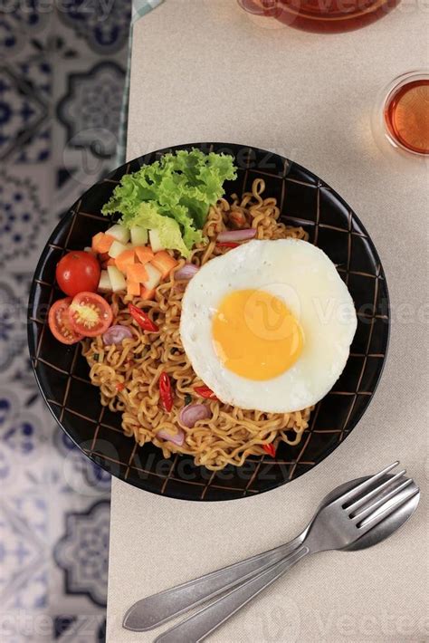 Indomie Goreng or Mie Goreng, Indonesian Popular Instant Noodle. Served ...