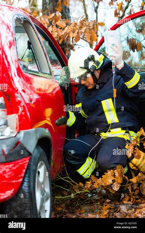 accident - fire rescue accident victims from car Stock Photo - Alamy