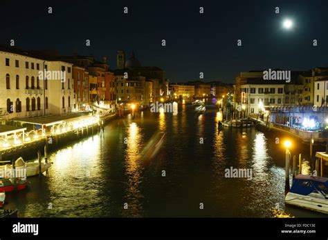 Grand Canal night view with light reflection on water and ships ...