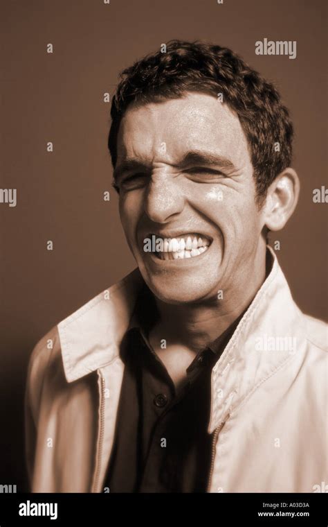 Man gritting teeth Stock Photo - Alamy