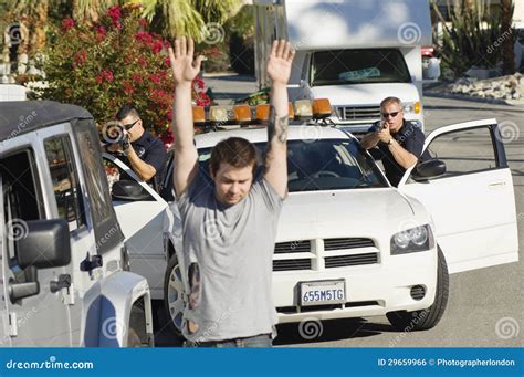 Police Officer Arresting Young Man Stock Photo - Image: 29659966