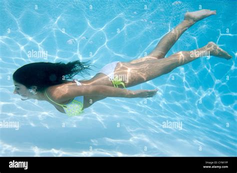 Woman swimming underwater Stock Photo - Alamy