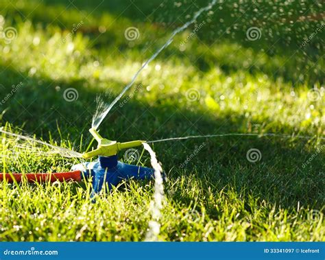 Irrigation of green grass stock image. Image of lawn - 33341097