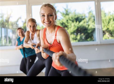 people together in tug of war competition as teambuilding exercise. Gym ...