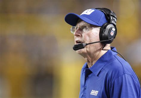 New York Giants head coach Tom Coughlin looks at the scoreboard against ...