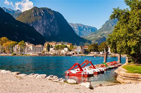 Beautiful Riva Del Garda Cityscape with Vibrant Red Pedal Boats Parked ...