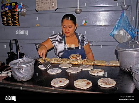 Woman cooking pupusas in a pupuseria, San Salvador, El Salvador Stock ...