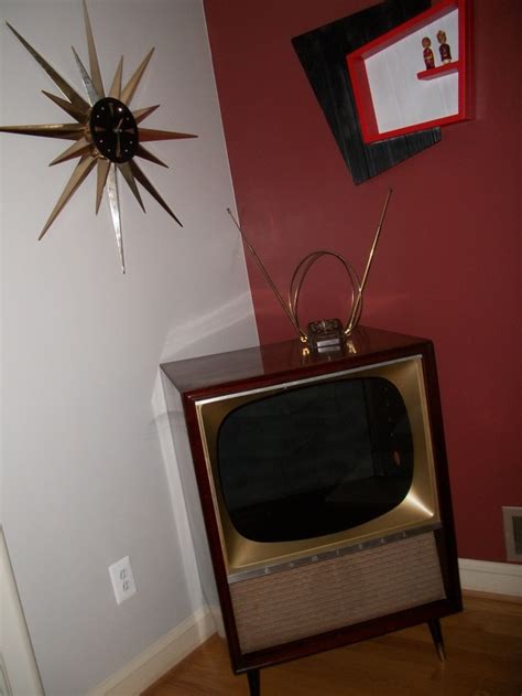 Vintage television with rabbit ear antennae - love the kitchy wall decoration too. Before the ...