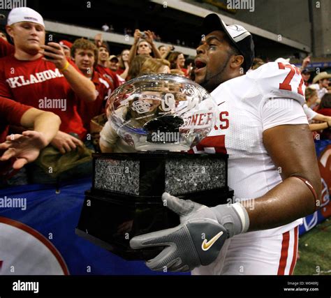 University of Oklahoma offensive lineman Sherrone Moore (77) holds the Big 12 Championship ...