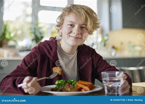 Portrait of Teeange Girl Eating Vegan Meal Sitting at Table in Kitchen at Home Stock Photo ...