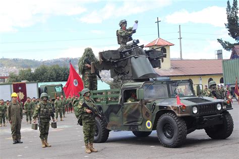 Ecuadorian Army soldiers from the Artillery and Logistics branches along a Humvee with a M45 ...