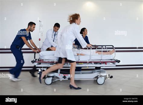 Hospital staff rushing patient to operating room Stock Photo - Alamy