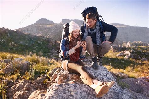 Young couple with backpacks hiking - Stock Image - F018/0457 - Science Photo Library