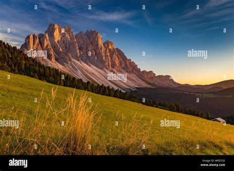 Sunset sunlight on the Odle massif, alpine grassland of the Funes Valley. Puez-Odle Natural Park ...