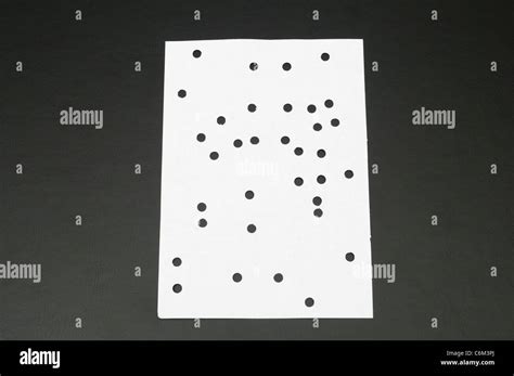 punched holes on white paper Stock Photo - Alamy